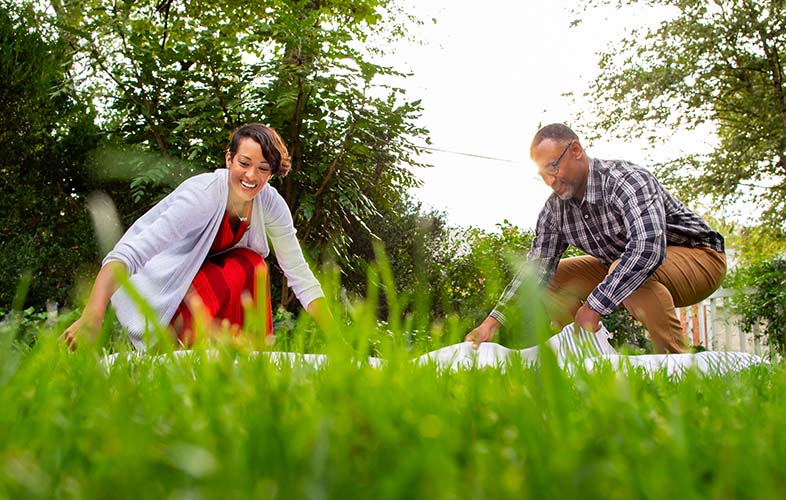 family eating picnic on healthy lawn