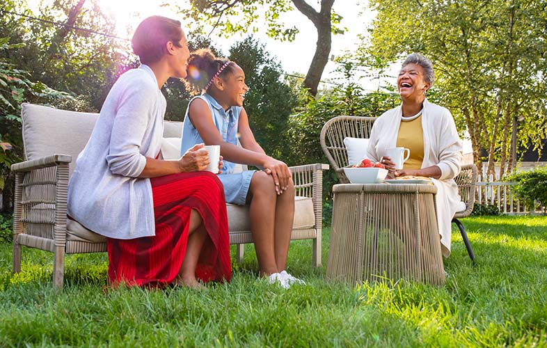 family enjoying coffee on lawn